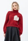 Suéter de malha de gola alta com coração bordado em vermelho